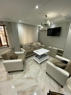 a living room with couches and a table and a tv at İsra home 2 in Istanbul