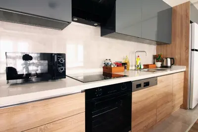 a kitchen with a black microwave and a stove at Excellent Apartments Fatih Golden Horn in Istanbul