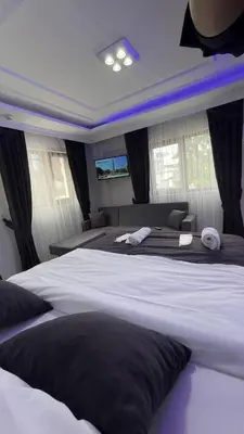 a bedroom with a large bed with black and white sheets at Özdemir Apart - Sultanahmet in Istanbul
