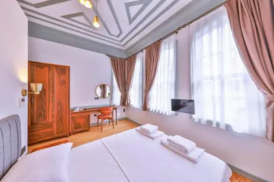 a bedroom with a bed with two towels on it at Va Mansion in Istanbul