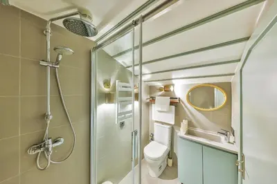 a bathroom with a shower and a toilet and a sink at Va Mansion in Istanbul