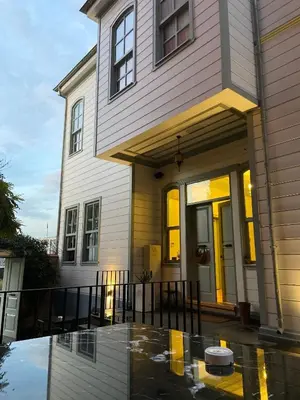 a house with a reflection in a puddle in front of it at Va Mansion in Istanbul