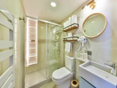 a bathroom with a toilet and a shower and a sink at Va Mansion in Istanbul