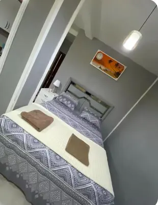 a small room with a bed with purple sheets at Cosy studio apartment in Istiklal central in Istanbul