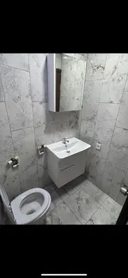 a bathroom with a toilet and a sink and a mirror at Cosy studio apartment in Istiklal central in Istanbul