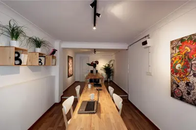 a dining room with a long table and white walls at Bomonti Residence charming flat in Istanbul