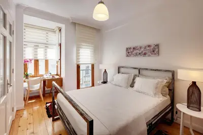 a bedroom with a bed and a table and a desk at Bomonti Residence charming flat in Istanbul