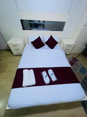 a bedroom with a white bed with slippers on it at Taksim Gold House Hotel in Istanbul