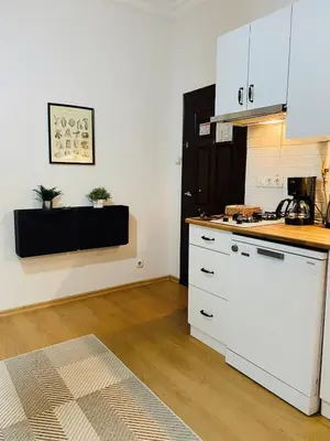 a kitchen with white cabinets and a counter top at Stylish & Comfort Apartment in Ortaköy in Istanbul