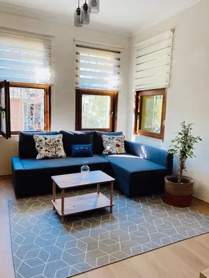 a living room with a blue couch and a table at Stylish & Comfort Apartment in Ortaköy in Istanbul