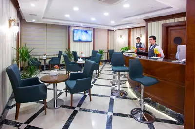 a bar in a hotel lobby with people at the counter at Alpinn Hotel Istanbul in Istanbul