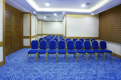a row of blue chairs in a room at Alpinn Hotel Istanbul in Istanbul