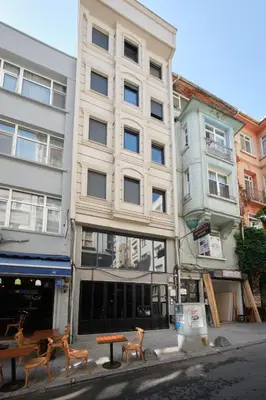 a building on a street with benches in front of it at aymira hotel pangaltı in Istanbul