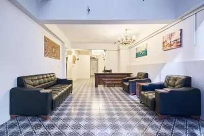 a waiting room with couches and a piano at aymira hotel pangaltı in Istanbul