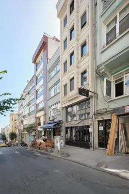 an empty city street with a building on the corner at aymira hotel pangaltı in Istanbul