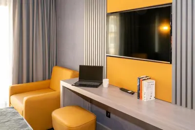 a room with a desk with a laptop and a chair at Icon Hotel Bomonti in Istanbul