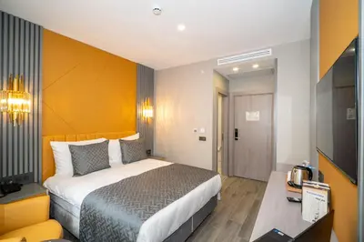 a hotel room with a bed and a television at Icon Hotel Bomonti in Istanbul