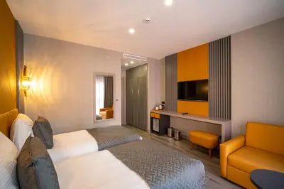 a hotel room with a bed and a couch at Icon Hotel Bomonti in Istanbul