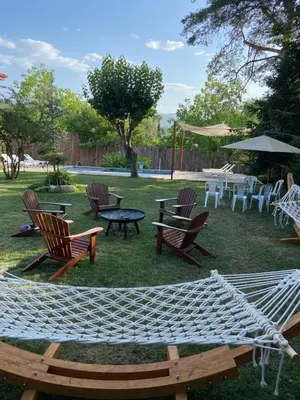 a group of chairs and tables and a hammock at Efe Köy Evi in Sapanca
