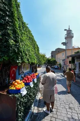 a man walking past a fruit stand on a street at Taksim Private Terrace Close to Antique Store Galata Port Cihangir in Istanbul