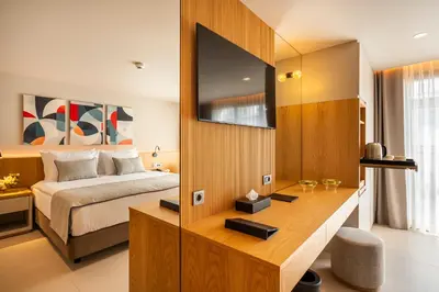 a bedroom with a bed and a desk with a television at ERK Hotel in Istanbul