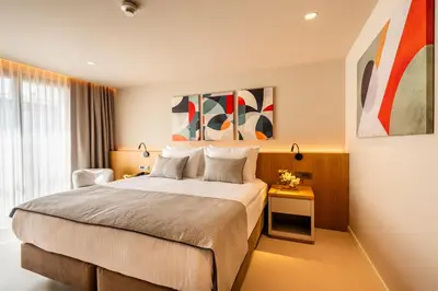 a hotel room with a bed and a chair at ERK Hotel in Istanbul