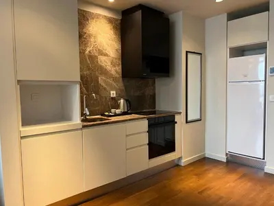 a kitchen with white cabinets and a counter top at huzurlu ve şirin in Istanbul