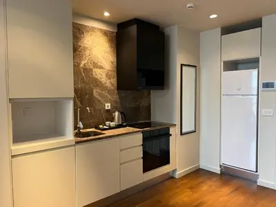 a kitchen with white cabinets and a counter top at huzurlu ve şirin in Istanbul