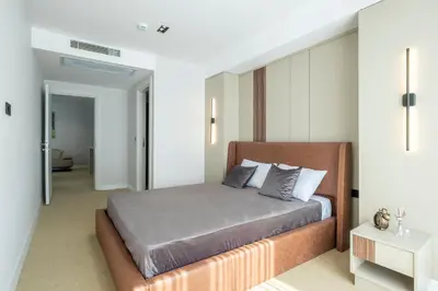 a bedroom with a bed and a white wall at Euphrates Hotel Bursa in İhsaniye