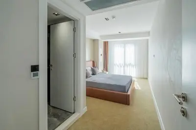 a bedroom with a bed and a large mirror at Euphrates Hotel Bursa in İhsaniye