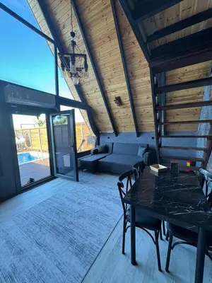 a living room with a table and a couch at Club Armada Bungalow Hotel Sapanca in Sapanca