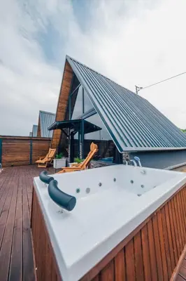 a hot tub on the deck of a house at Club Armada Bungalow Hotel Sapanca in Sapanca