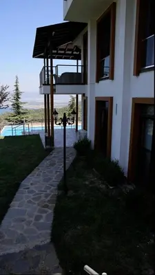 a house with a walkway next to a building at Blue Resort in Ovaakçaköy