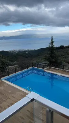 a large swimming pool with a view of the ocean at Blue Resort in Ovaakçaköy