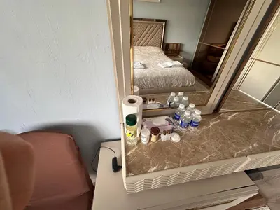 a hotel room with a mirror and a bed at ALTAY Airport SUİT in Tayakadın
