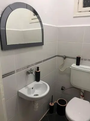 a bathroom with a sink and a mirror at Spacious flat with wide view in Istanbul