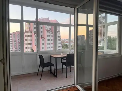 a room with a table and chairs and windows at Spacious flat with wide view in Istanbul