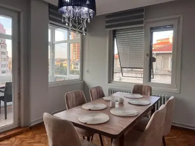 a dining room with a wooden table and chairs at Spacious flat with wide view in Istanbul