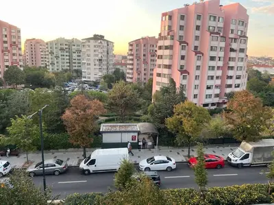 a parking lot with cars in a city with tall buildings at Spacious flat with wide view in Istanbul