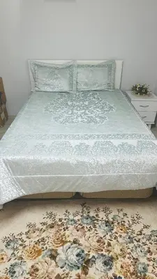 a bedroom with a bed with a floral rug at Farm Village in Sakarya