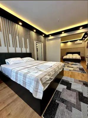 a bedroom with a large bed and two rugs at The Port Palace Hotel in Istanbul
