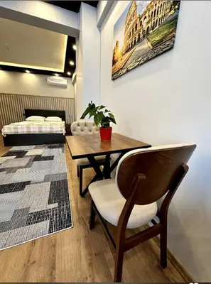 a room with a table and a chair and a bed at The Port Palace Hotel in Istanbul