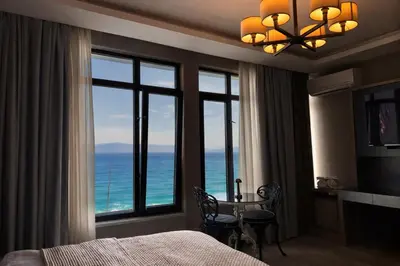 a bedroom with a room with a view of the ocean at Yalı Bahçe Mudanya in Burgaz