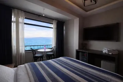 a hotel room with a bed and a view of the ocean at Yalı Bahçe Mudanya in Burgaz