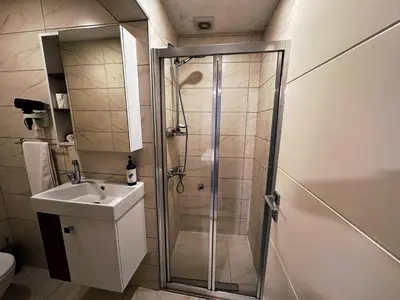 a bathroom with a shower and a sink at Yalı Bahçe Mudanya in Burgaz