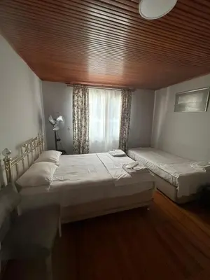 two beds in a room with a window at WOODEN House ÜSKÜDAR in Istanbul