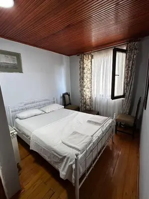 a bedroom with a white bed and a window at WOODEN House ÜSKÜDAR in Istanbul
