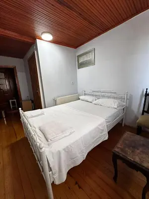 a white bed in a room with a wooden ceiling at WOODEN House ÜSKÜDAR in Istanbul