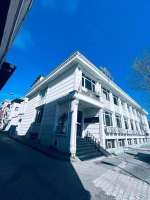 a white building with stairs in front of a street at Grand Ararat Hotel in Istanbul