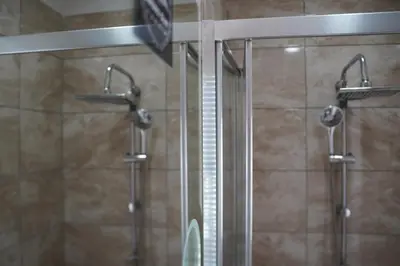 a shower in a bathroom with a glass door at Sword Suit Hotel in Istanbul